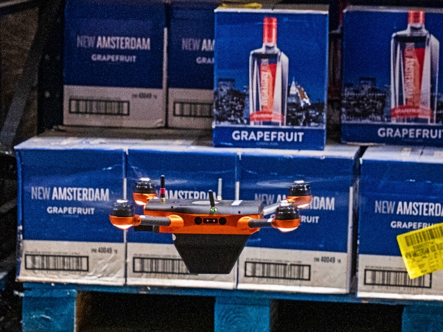 A Corvus One autonomous inventory drone scanning warehouse racking at Southern Glazer’s Wine & Spirits distribution center, enabling real-time inventory visibility in a high-bay storage environment