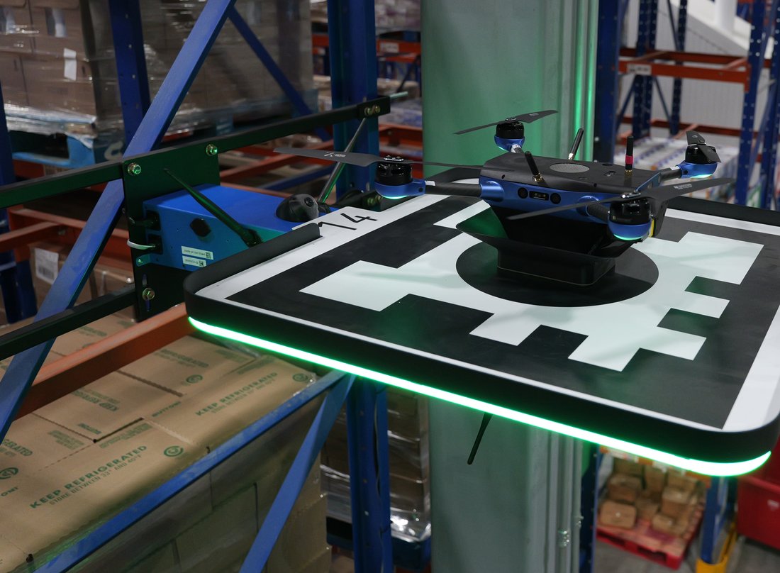 Corvus One drone on its charging pad in a refrigerated warehouse