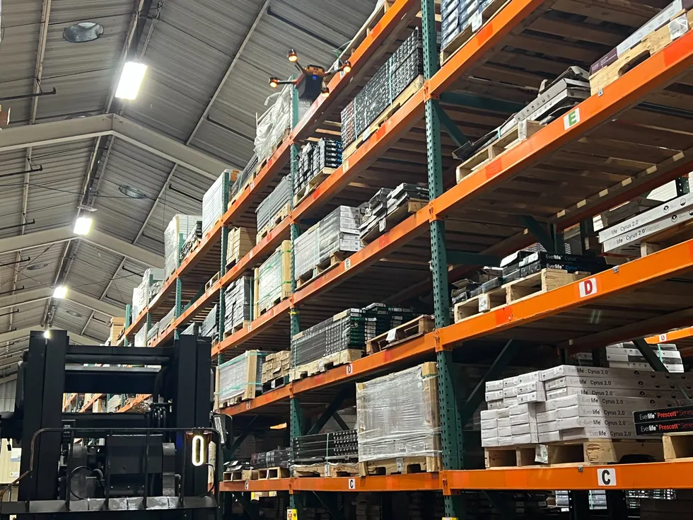 Corvus One inventory drone scanning high racks and a Corvus Trident sensor on a forklift in a California warehouse
