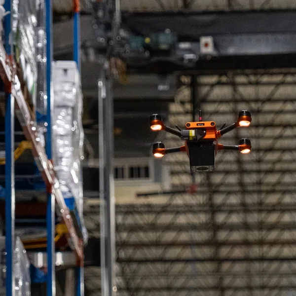 A Corvus One autonomous warehouse drone scans palletized beverage inventory at Southern Glazer's Wine & Spirits, capturing barcode and pallet position data to improve inventory accuracy