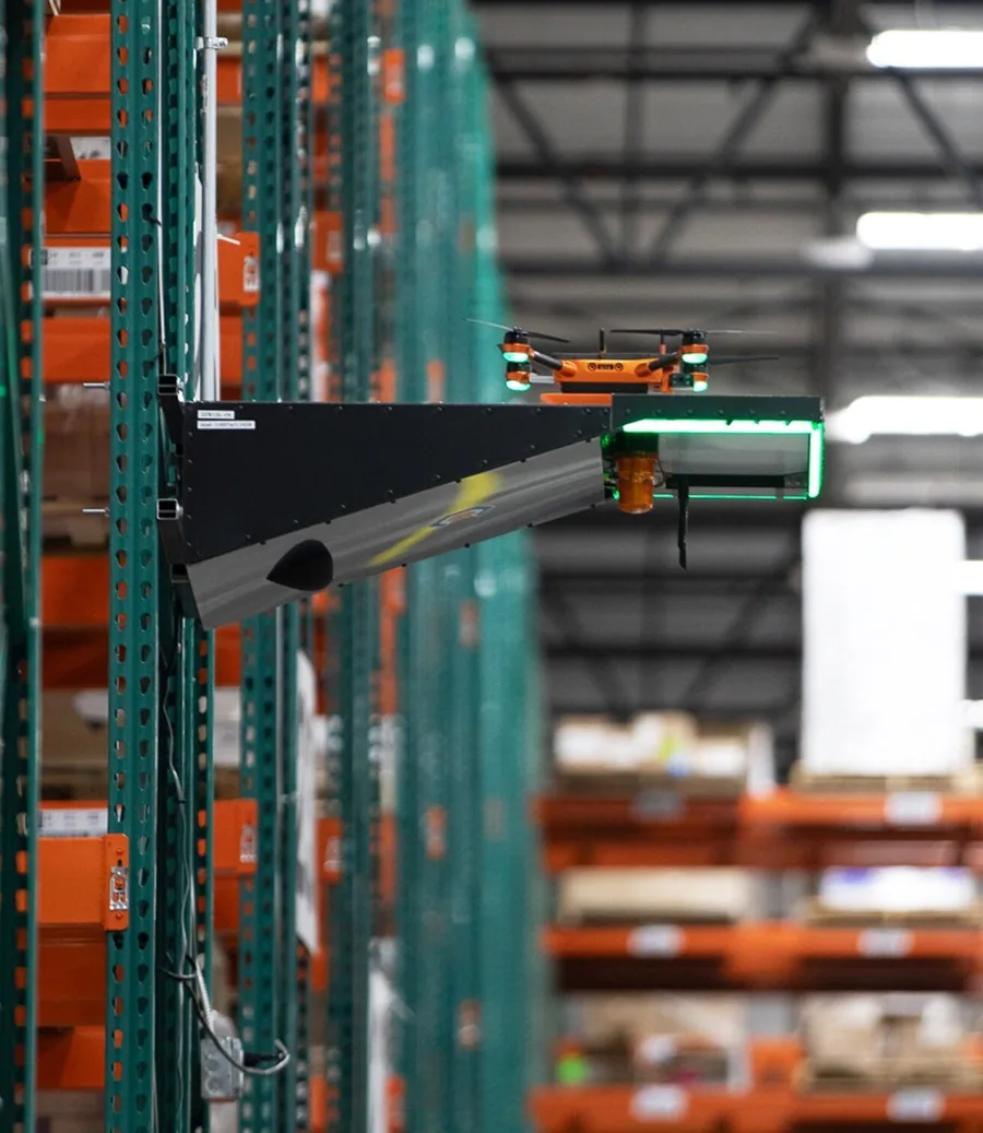 A Corvus One drone in flight inside Staci Americas' New Jersey distribution center capturing inventory data on tall pallet racking